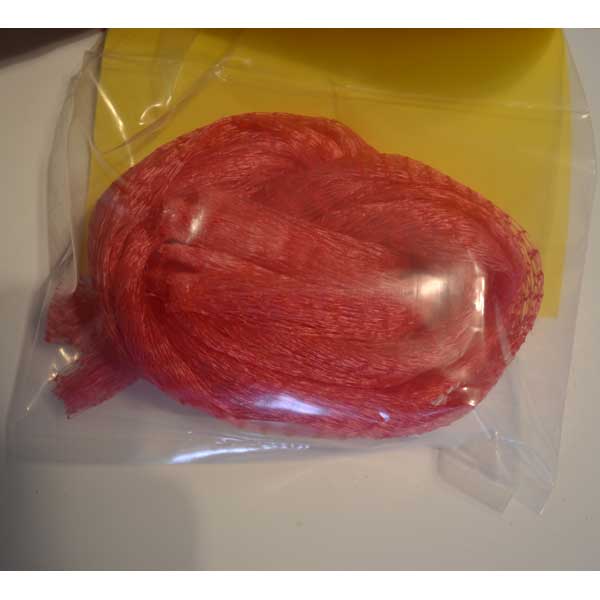 Red chum bags in a clear plastic bag with a yellow label.
