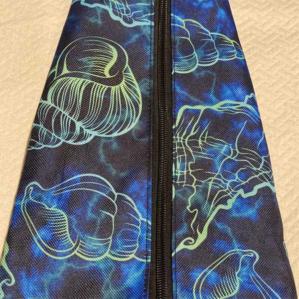 Pouch with blue and green abstract design on a beige background