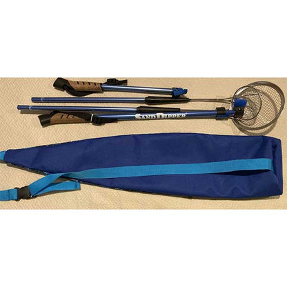 Shell scoop with blue carrying case on a beige surface