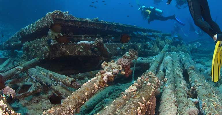 Bridge pile sections underwater with divers