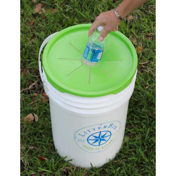 White bucket with green lid labeled 'Litter Bix' on grass
