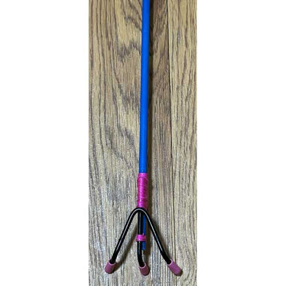 Blue and black tool with pink accents on a wooden floor