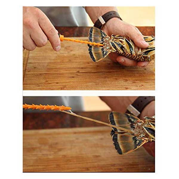 Person using a tool to insert tool in a live lobster on a wooden surface