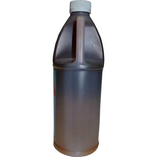 Bottle of dark liquid with a white cap on a white background