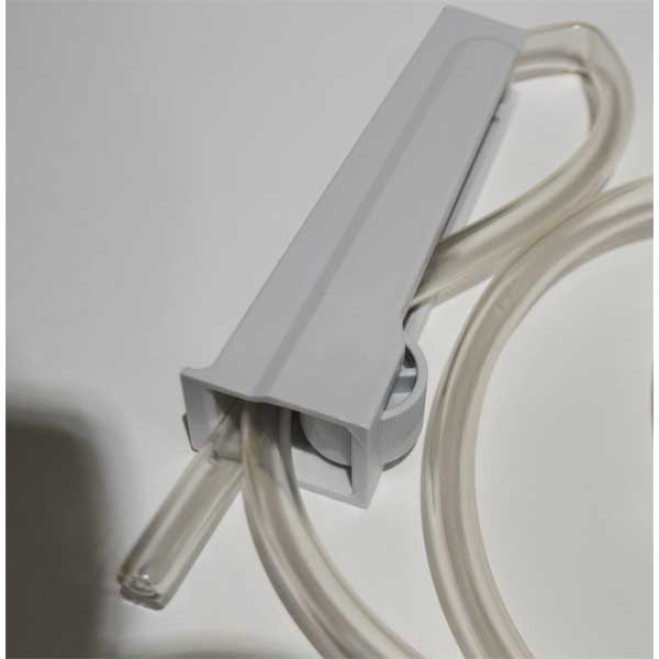 Gray plastic component with clear tubing on a light gray background