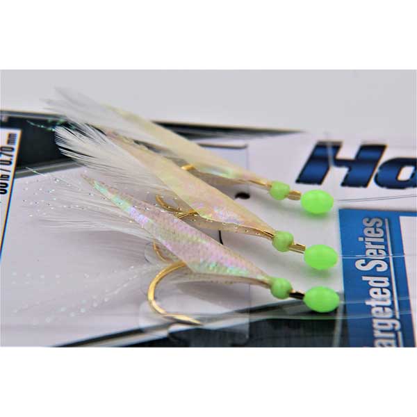 Fishing jigs with gold hooks and green beads on a white background