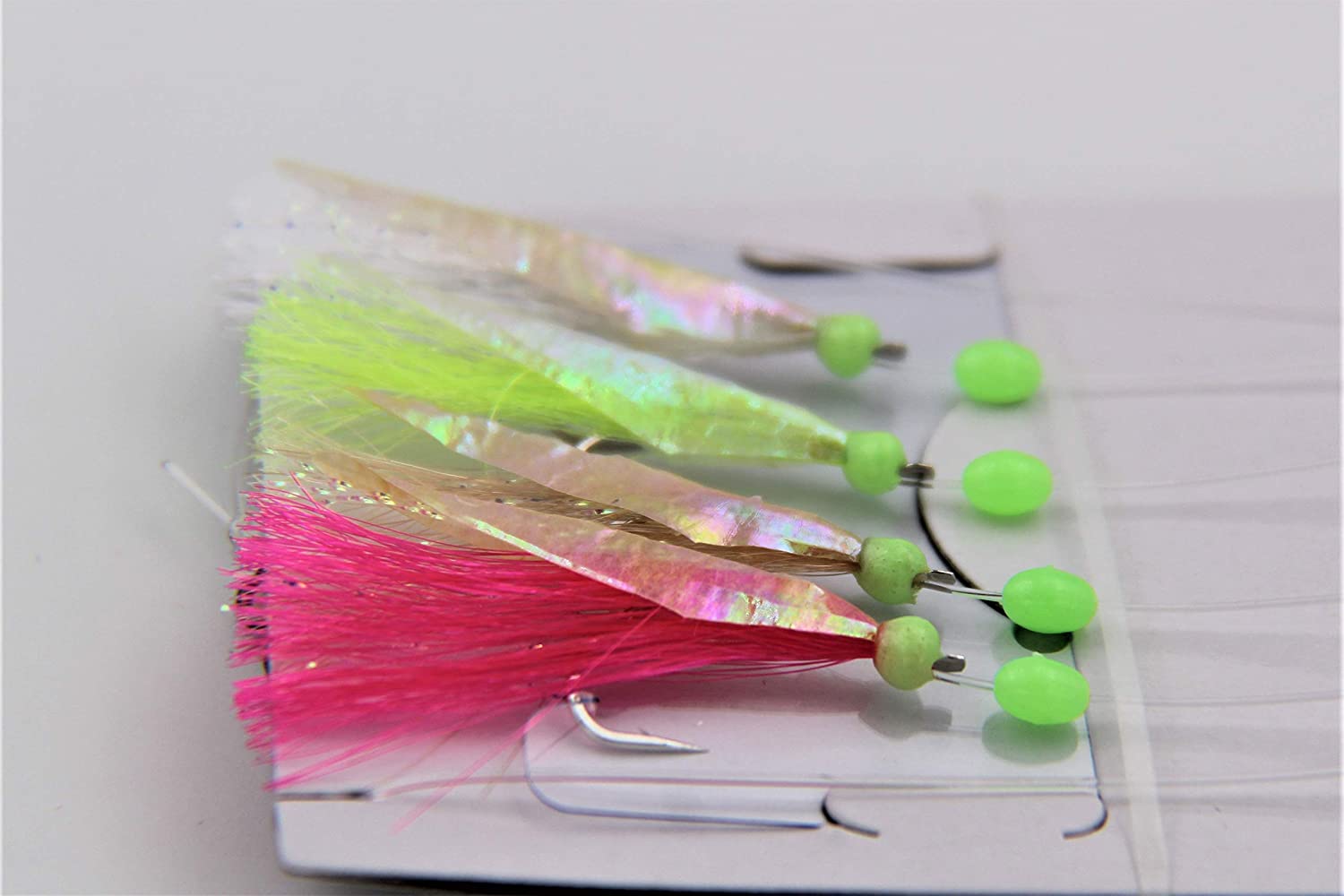 Fishing lures with colorful skirts on a white background